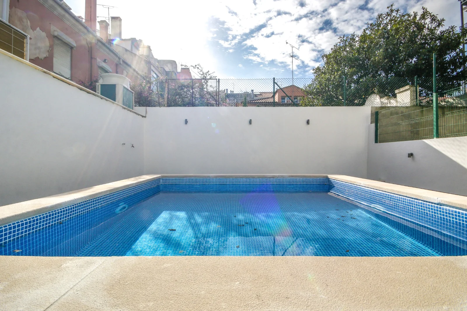 Piscina exterior de mosaico azul no Saldanha Pool & Garden